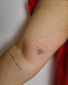 a woman with a small tattoo on her arm