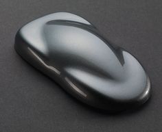 a shiny silver object on a black surface with no one in it's image