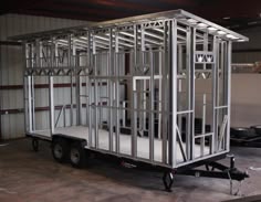 a trailer that is sitting inside of a building with metal framing on the back and sides