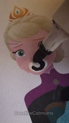 someone is painting the floor with a princess's face on it and she has blue eyes
