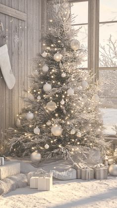 a decorated christmas tree in front of a window
