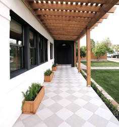 an outdoor patio with wooden planters on the side