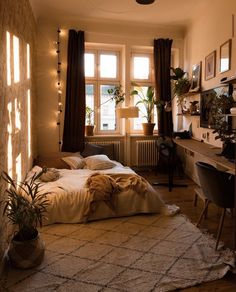a bed sitting in a bedroom next to a desk with a computer on top of it