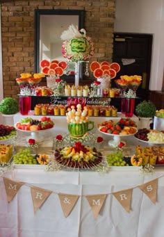 a table filled with lots of different types of fruits and desserts on top of it