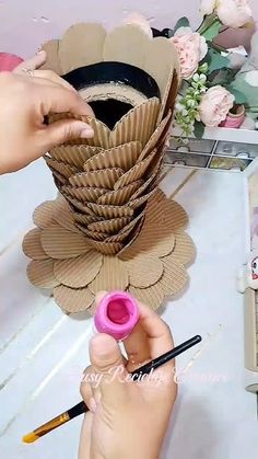 someone is making a flower out of paper