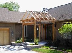 a house with a wooden pergolan attached to it