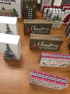 several wooden boxes with christmas wishes on them sitting on a table next to other cards