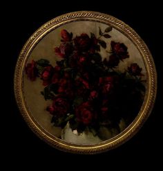 a vase filled with red flowers on top of a table