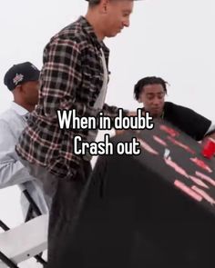 two men standing next to each other in front of a table with the words when in doubt crash out