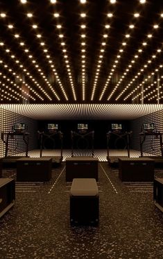 an empty room with lights on the ceiling