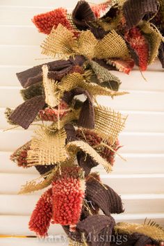 a close up of a wreath made out of burlucks and other things