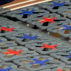 several pieces of plastic with red, blue and orange designs on them sitting next to each other