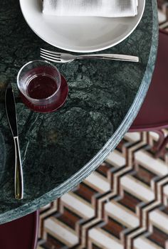 the table is set with silverware, wine glasses and napkins on top of it