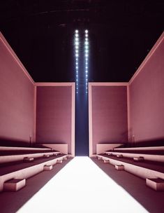 an empty stage with steps leading up to the ceiling and lights shining down on the floor