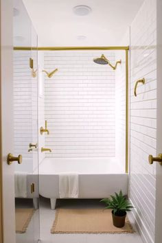 a bathroom with a tub, shower head and rug