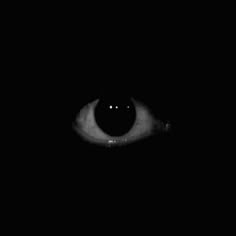 an evil looking eye in the dark