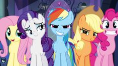 many different colored ponies are standing together