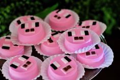 some pink cupcakes with black and white designs on them