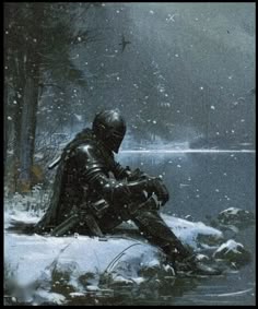 a man sitting on top of a snow covered ground