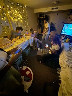 several people sitting in a room playing video games