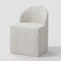 a white and blue patterned chair on a gray background