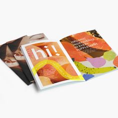 three books are stacked on top of each other, one is open and the other has an image of a woman's face