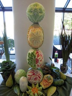 a table topped with lots of different types of fruits and vegetables on top of each other