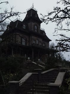 an old house with stairs leading up to it