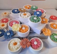 there are many cupcakes with flowers in them