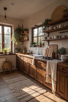 a kitchen filled with lots of wooden cabinets and counter top space next to a window