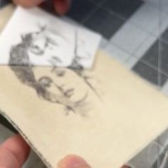 a person holding an old photo in their left hand