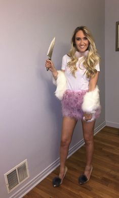 a woman is dressed up as a bunny with a knife in her hand and wearing furry shorts