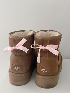 #uggs #bows #pink #uggseason #uggstyle #fallseason #falloutfitideas #falloutfitswomen #falloutfitsforwomen #octobervibes Uggs With A Bow, Uggs Bow, Bows On Uggs, Uggs Ribbon, Ribbon Uggs, Uggs With Pink Ribbon, Brown Uggs With Pink Bow, Pink Ugg With Bows, Pink Uggs Bows