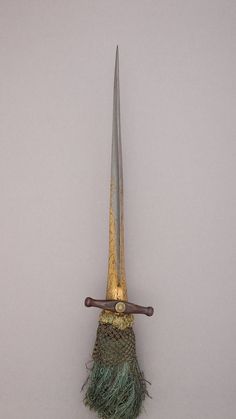 a pair of large metal scissors sitting on top of a piece of cloth next to a knife