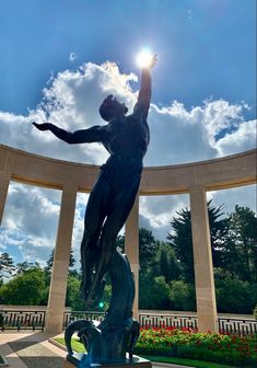 there is a statue in the middle of a park