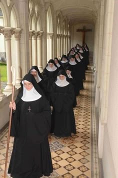 a group of women dressed in black are lined up