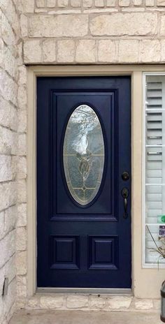 a blue front door with a round glass window