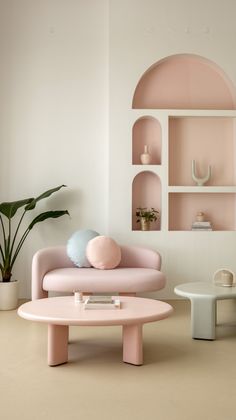 a living room with pink furniture and shelves on the wall, including a coffee table