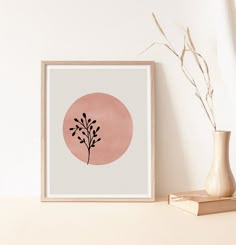 a pink and white painting on a wall next to a vase