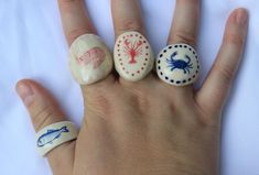 three different types of painted rocks on someone's hand