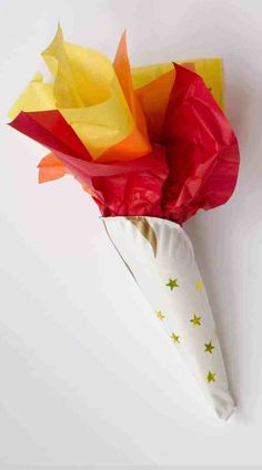a bouquet of flowers wrapped in tissue paper on a white surface with stars and stripes