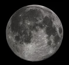 the full moon is shown in black and white