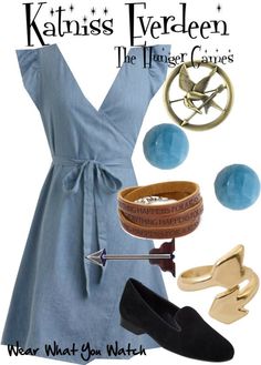 a woman in blue dress and black shoes with accessories