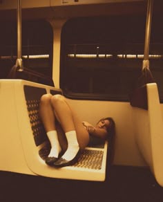 a woman sitting on a bus with her legs crossed