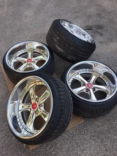 four rims and tires are stacked on top of each other