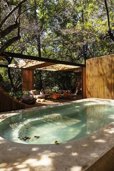 an outdoor swimming pool surrounded by trees