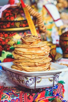 a stack of pancakes sitting on top of a white plate