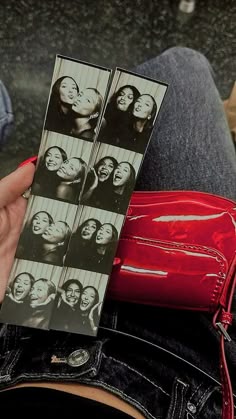 a person holding up an old photo in their lap