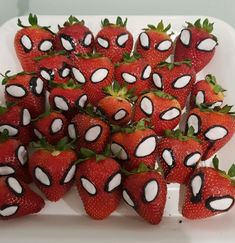 strawberries are arranged in the shape of spider - man eyes on a white tray