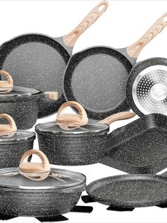 an assortment of black pots and pans with wooden handles are shown in this image